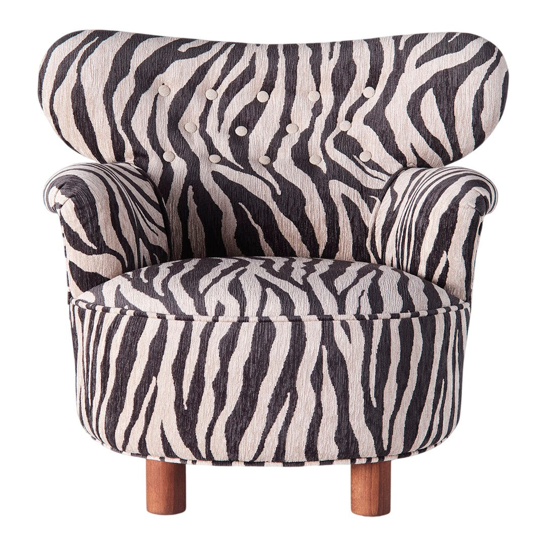 Zebra-striped armchair in black and cream with tufted detailing and wooden legs. Perfect for bold decor.