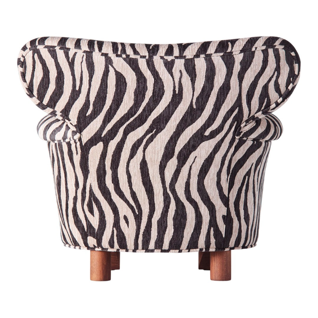 Black and white zebra stripe patterned chair with rounded back and wooden legs. Stylish and bold statement piece.