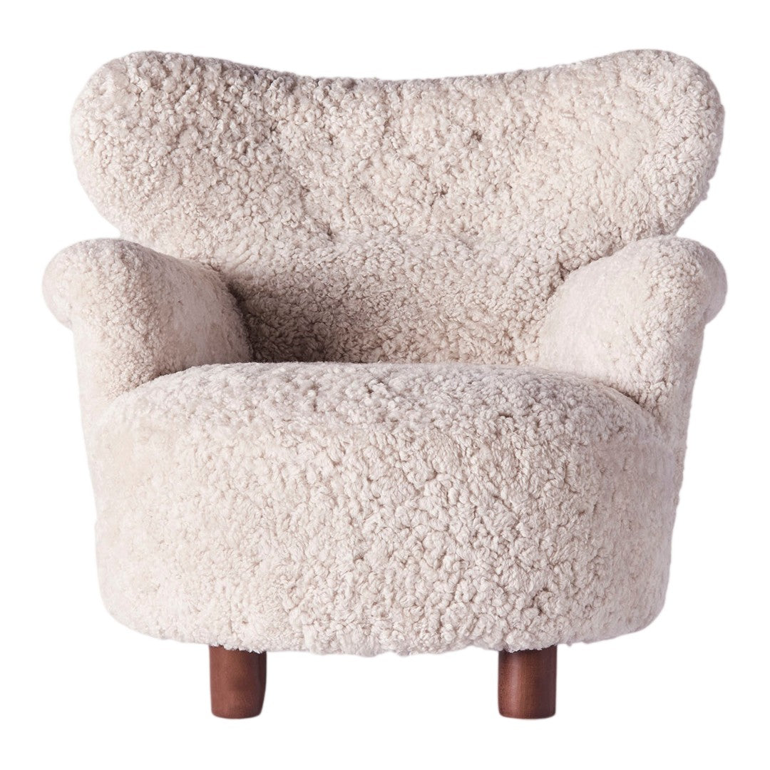 Cream-colored cozy chair with a textured, fluffy upholstery and stylish wooden legs. Perfect for modern decor.