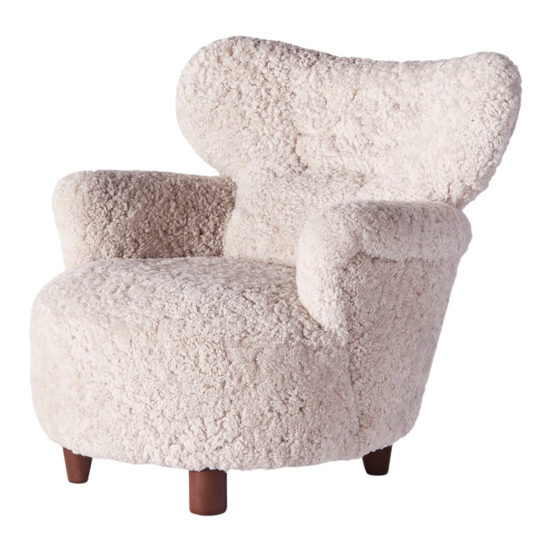 Cream-colored, textured armchair with a fluffy, inviting appearance and curved silhouette. Perfect for cozy interiors.