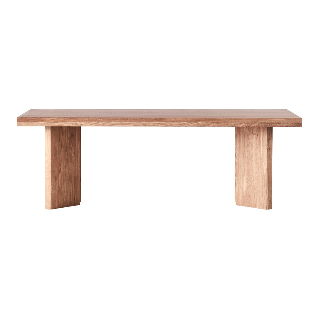 Light natural wood dining table with a smooth finish and minimalist design, showcasing warm beige and light brown tones.