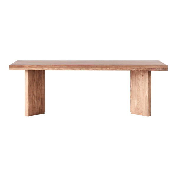 Light natural wood dining table with a smooth finish and minimalist design, showcasing warm beige and light brown tones.