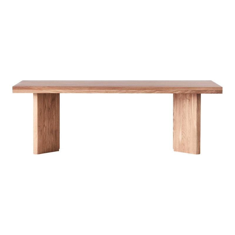 Light natural wood dining table with a smooth finish and minimalist design, showcasing warm beige and light brown tones.