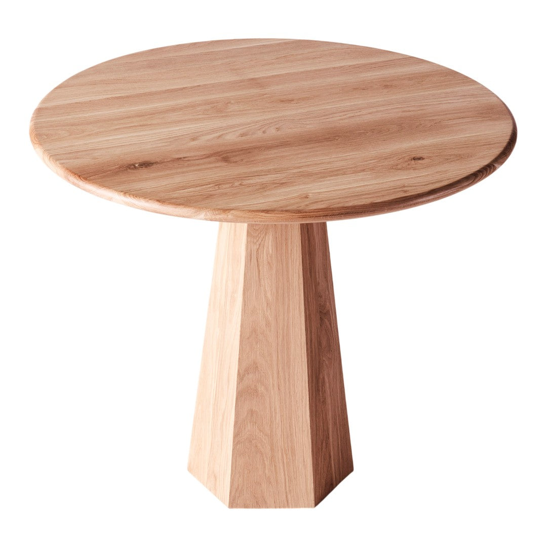 Light oak round table with a natural wood grain pattern and a geometric pedestal base in a soft beige tone.