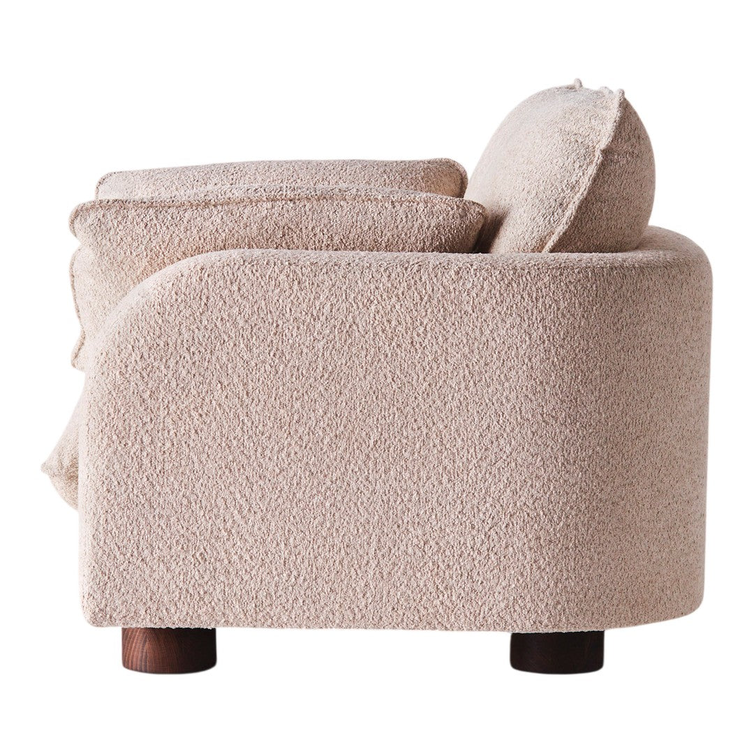 Textured beige sofa with a rounded design and a cozy, plush finish. Perfect for modern interiors.