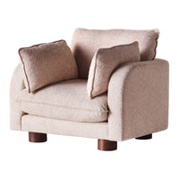 Beige textured armchair with two matching cushions and wooden legs, creating a cozy and modern look.