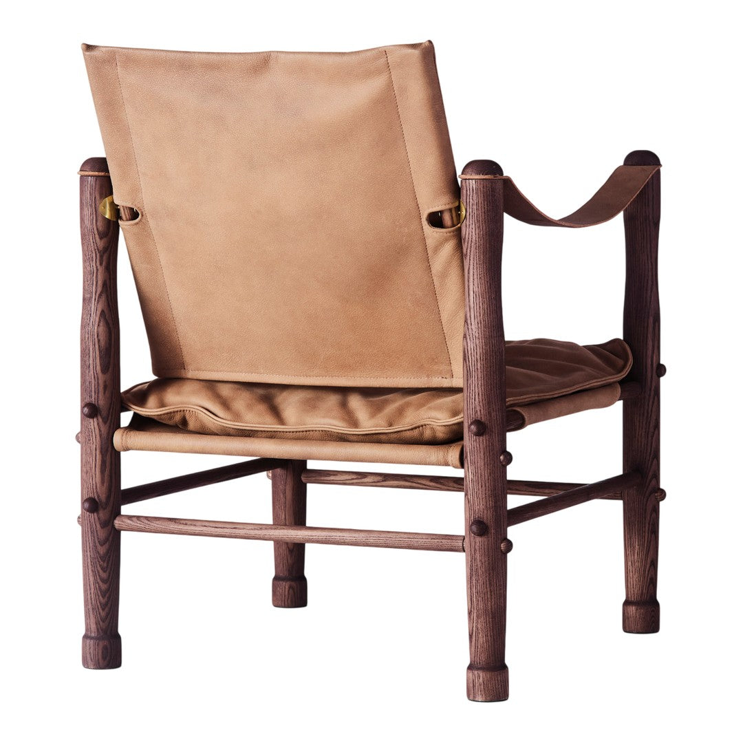 Tan leather chair with a rustic wooden frame, featuring simple lines and a minimalistic design. Perfect for modern spaces.