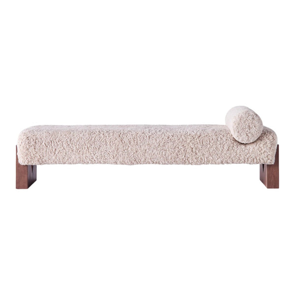 Light beige bench with a fluffy, textured fabric and a rounded cushion, featuring a warm wooden base.