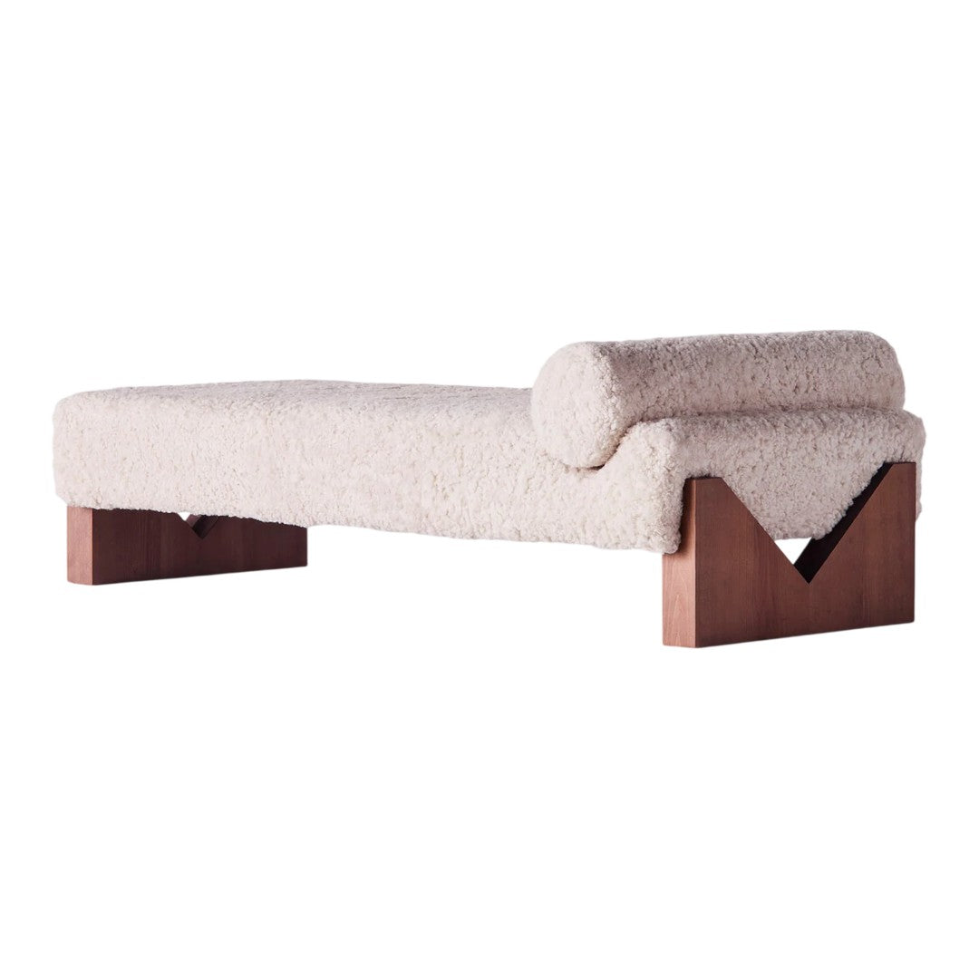 Cream-colored lounge chair with a textured finish and dark wood accents, featuring a minimalist design.