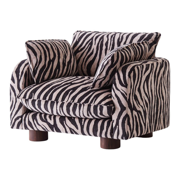 Black and cream zebra print armchair with plush cushions and rounded wooden legs. Stylish and bold accent furniture.