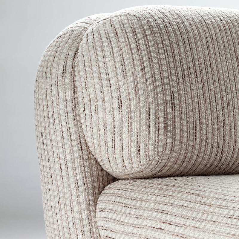 Textured cream upholstery with subtle vertical stripes, adding elegance and warmth to modern decor.