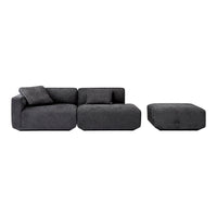 Modern dark gray sectional sofa with plush texture, featuring clean lines and a matching ottoman. Perfect for contemporary spaces.