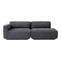 Modern dark gray sectional sofa with a minimalist design, featuring a soft velvet texture and smooth lines.