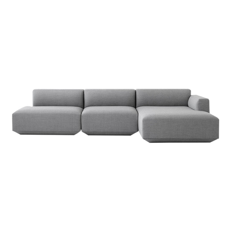 Modern grey sectional sofa with a minimalist design and smooth fabric upholstery. Ideal for contemporary living spaces.