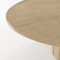 Natural light wood round tabletop with a smooth, unadorned surface and subtle grain pattern.