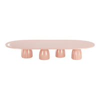 Pink oval table with curved edges and four rounded pedestal legs, featuring a smooth, glossy finish.
