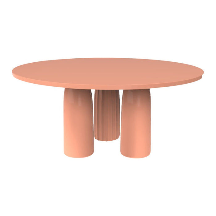 Round table in soft peach color with smooth, minimalist design and three textured cylindrical legs.