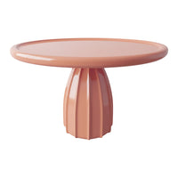 Peach-colored round table with a textured fluted pedestal and smooth glossy surface, perfect for modern decor.