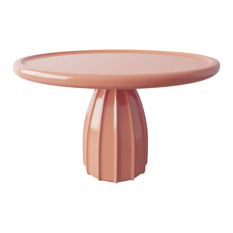 Peach-colored round table with a textured fluted pedestal and smooth glossy surface, perfect for modern decor.