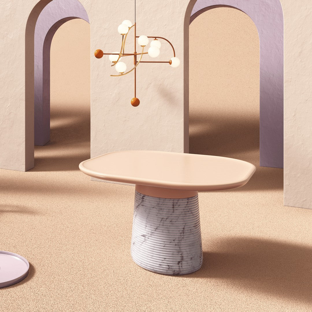 Elegant blush tabletop with a marble-patterned base, complementing soft pastel arches in a serene indoor setting.