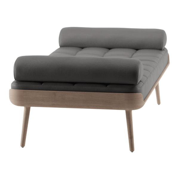 Gray tufted lounge chair with wooden legs and a modern design, featuring a sleek, minimalist aesthetic.