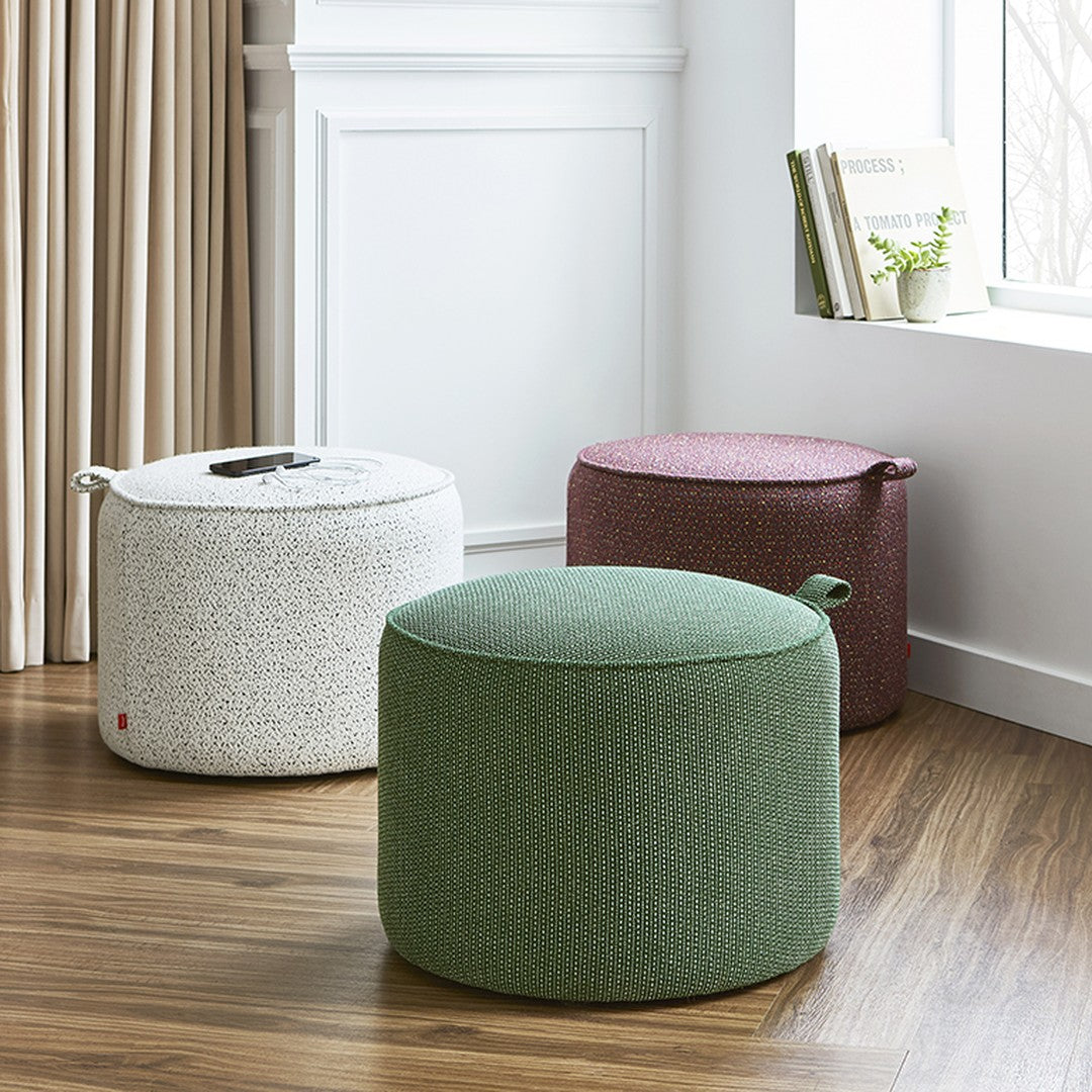 Colorful round poufs in green, white, and burgundy, featuring textured patterns for stylish interior decor.