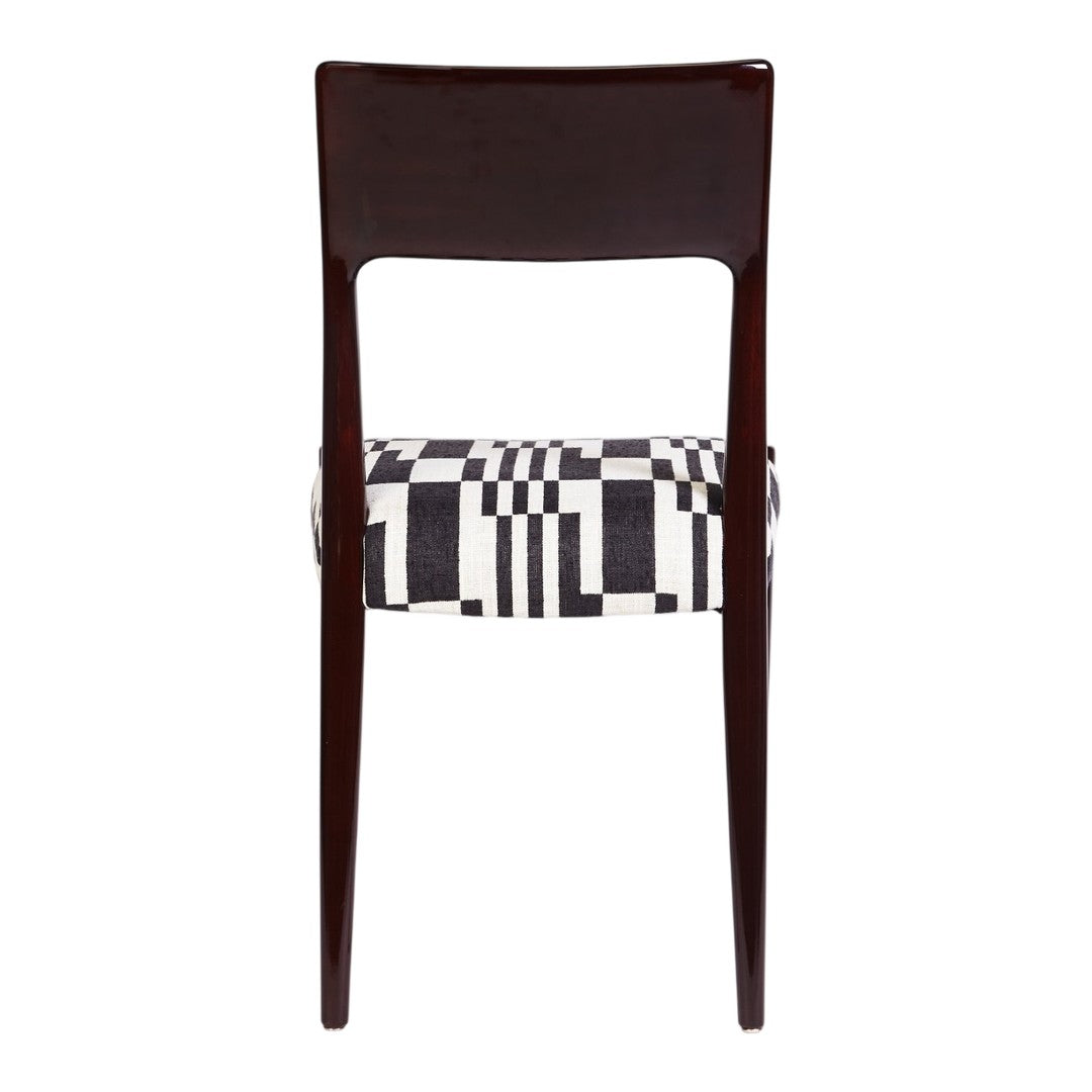 Black and white geometric patterned upholstery on a dark wood dining chair.
