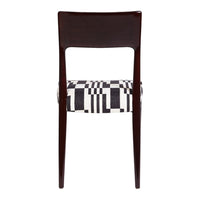 Black and white geometric patterned upholstery on a dark wood dining chair.