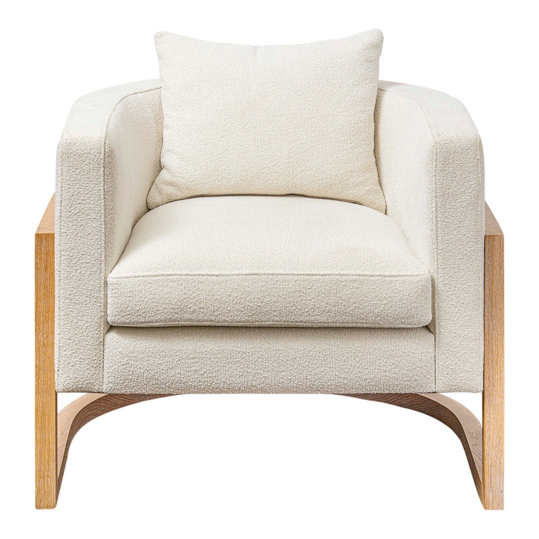 Cream upholstered armchair with a plush texture and light wooden legs, featuring a matching square cushion.