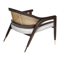 Mid-century chair featuring dark wood frame, natural caning, a soft gray cushion, and brass-tipped legs.
