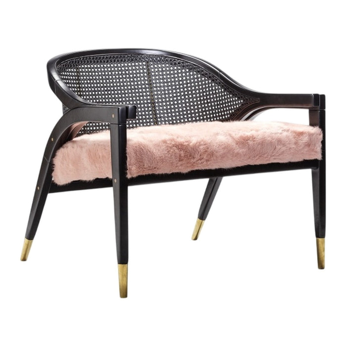 Black and gold accent chair with a soft pink faux fur cushion and caned back design. Elegant and modern decor piece.