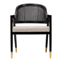 Black caned chair with cream upholstered seat and gold-tipped legs, featuring a modern pattern and stylish design.