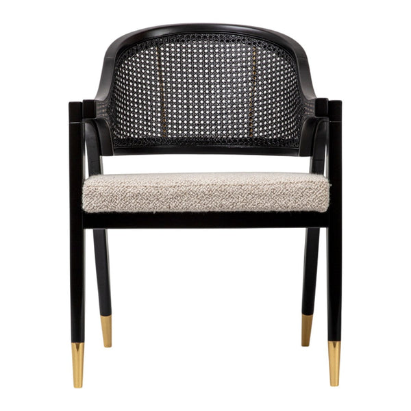 Black caned chair with cream upholstered seat and gold-tipped legs, featuring a modern pattern and stylish design.