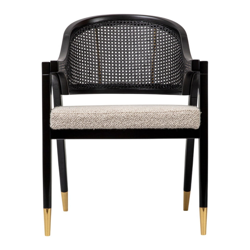 Black caned chair with cream upholstered seat and gold-tipped legs, featuring a modern pattern and stylish design.