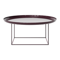 Round burgundy tray table with a sleek glass top and minimalist black metal base, perfect for modern decor.