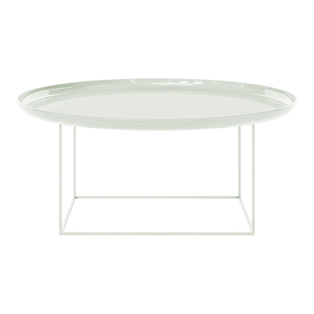 Light green oval coffee table with a glossy finish and minimalistic white metal frame. Elegant modern design.