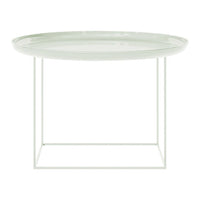 Modern round side table with a soft green glass top and a minimalist white metal frame. Stylish and elegant design.