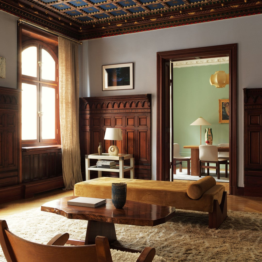 Elegant wooden accents with warm earth tones, intricate ceiling patterns, and rich blue, creating a cozy atmosphere.