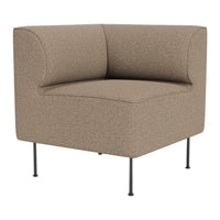 Tan upholstered corner chair with a textured pattern and slim black metal legs. Modern and minimalist design.