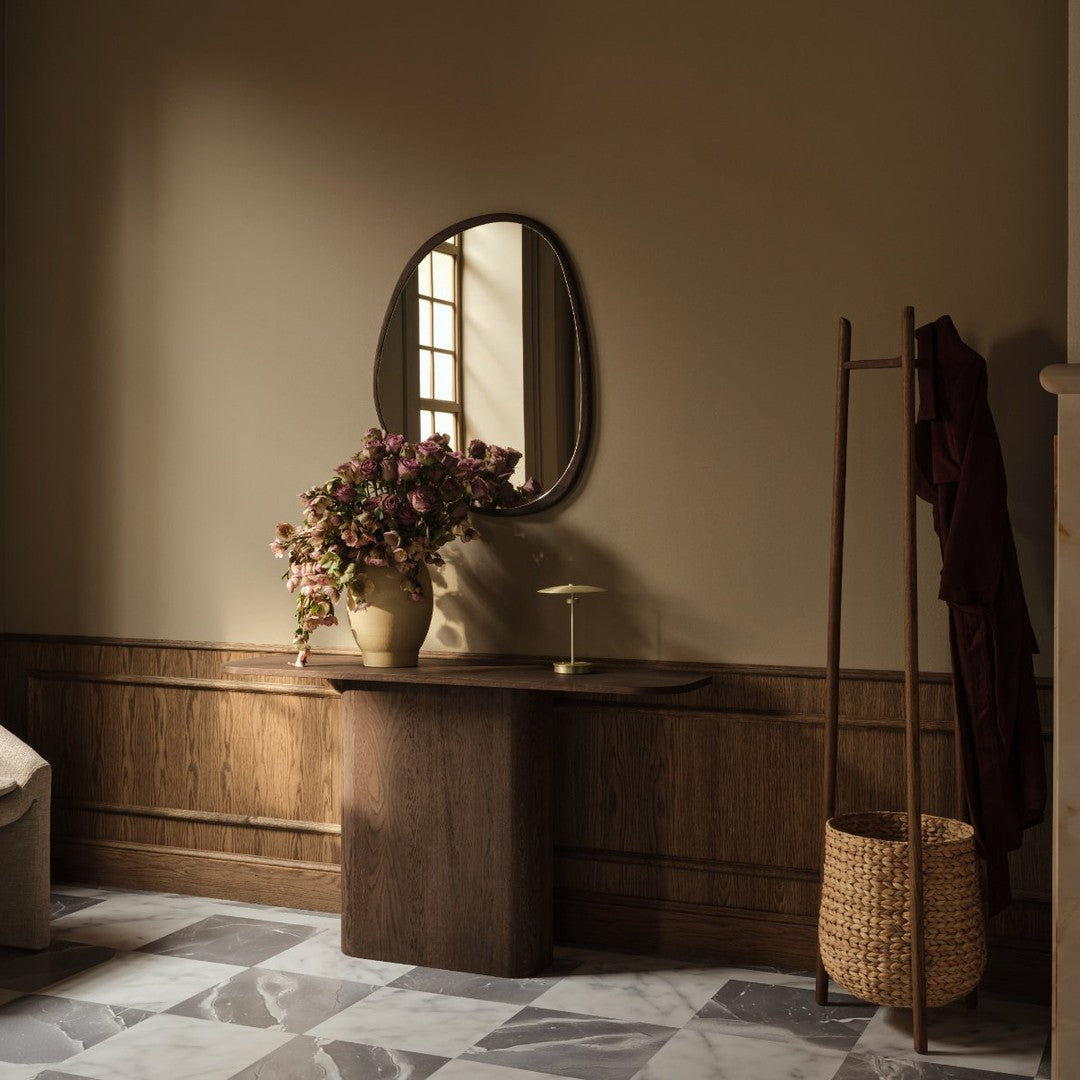 "Neutral beige walls, dark wood accents, and a marble-patterned floor create a warm, inviting atmosphere."