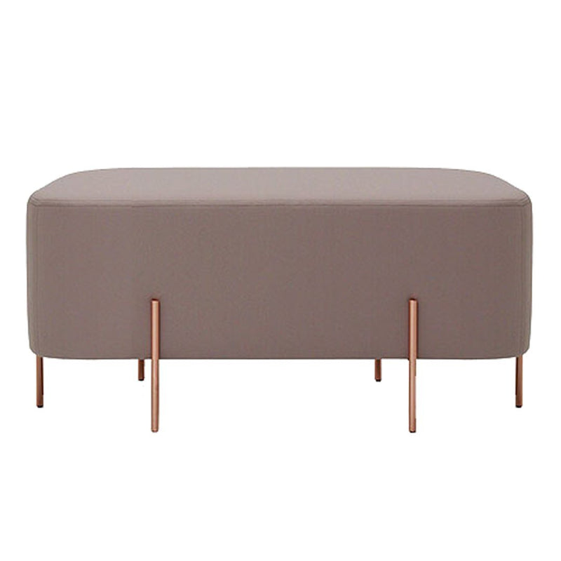 "Soft taupe ottoman with sleek copper legs, featuring a modern and minimalist design."
