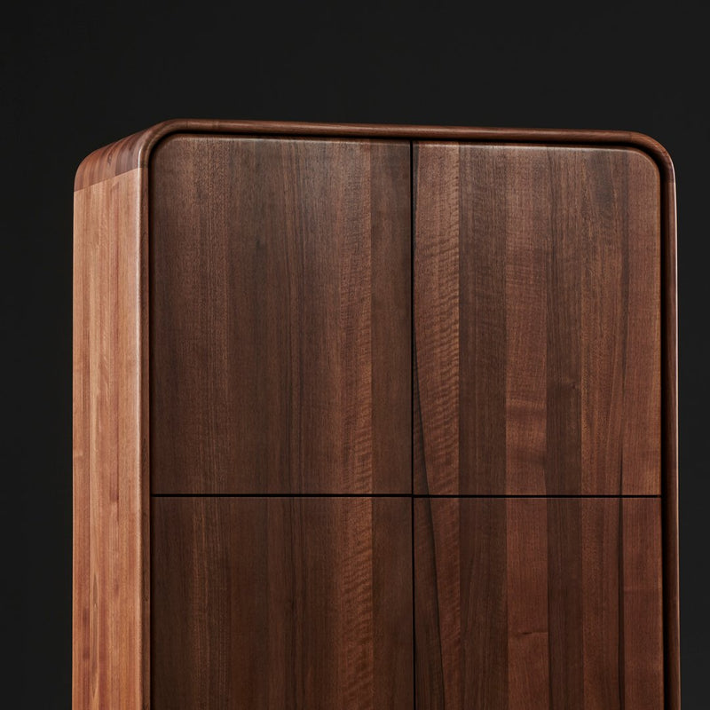 Elegant walnut wood cabinet featuring rich brown tones and smooth lines against a black background.