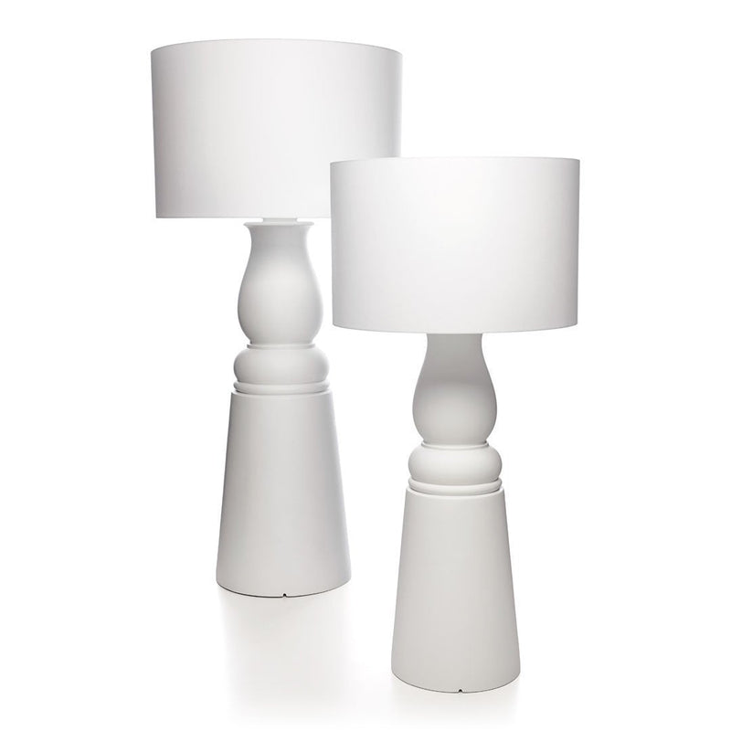 Set of two modern white table lamps with smooth, rounded shapes and cylindrical shades. Elegant and minimalist design.