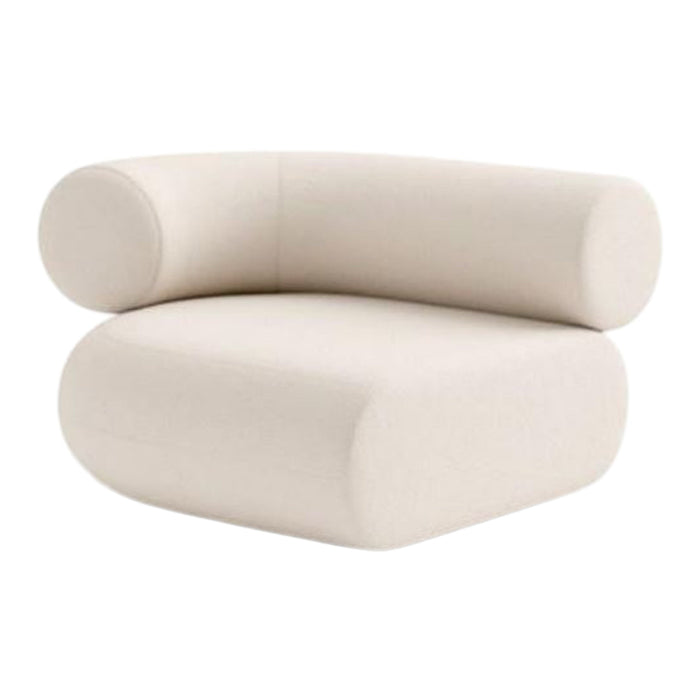 Beige, modern chair with rounded edges and a minimalist design, featuring a soft, textured upholstery.