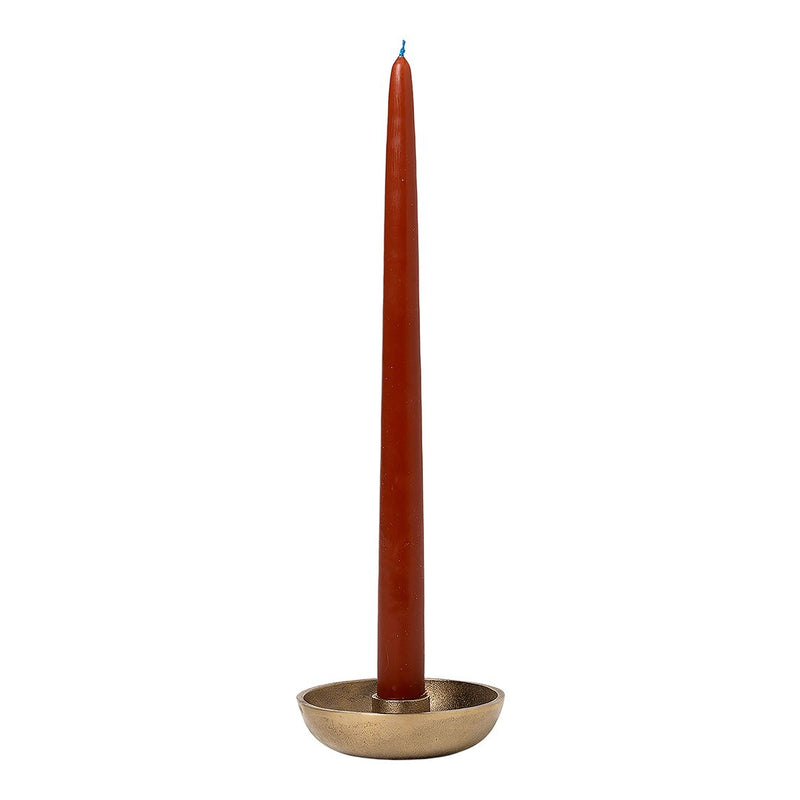 Tall rust-colored candle in a simple gold holder. Elegant design with smooth, solid colors. Perfect for decor.