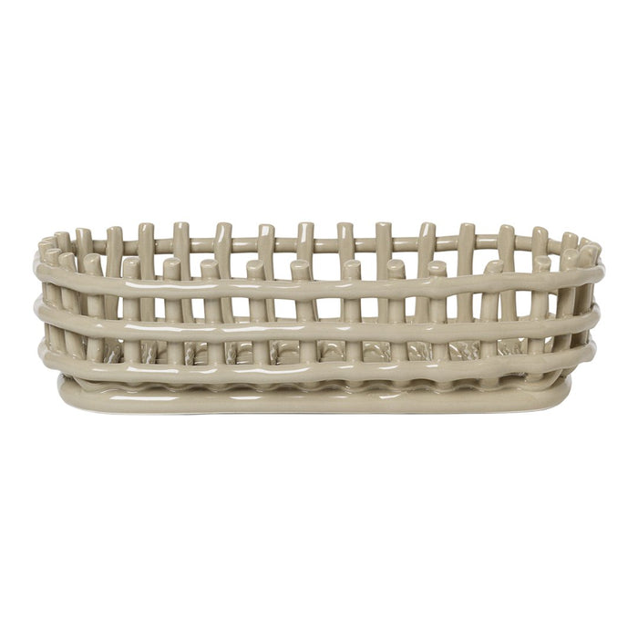 Light beige oval basket with a woven pattern and elevated edge for stylish storage. Perfect for home organization.
