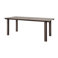 Brown rectangular dining table with a sleek, smooth surface and sturdy metallic legs. Ideal for modern interiors.