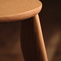 Light natural wood with smooth grain pattern, featuring round top and tapered leg design. Perfect for minimalist decor.