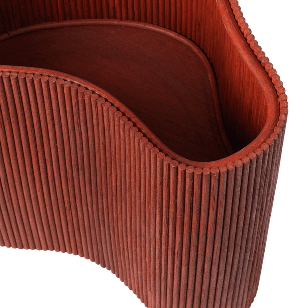 Rust-colored curved bowl with vertical ribbed pattern, perfect for modern decor.