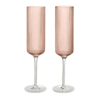 "Set of two ribbed, pink champagne flutes with clear glass stems, perfect for elegant entertaining."